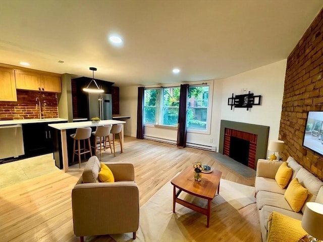 191 W Canton Unit 1, Boston, MA 02116 - living area with a fireplace, light wood-style flooring, recessed lighting, and a baseboard radiator