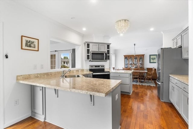 23 Brookstone Unit 23, Bridgewater, MA 02324 - kitchen with stainless steel appliances, a peninsula, open shelves, gray cabinetry, and crown molding
