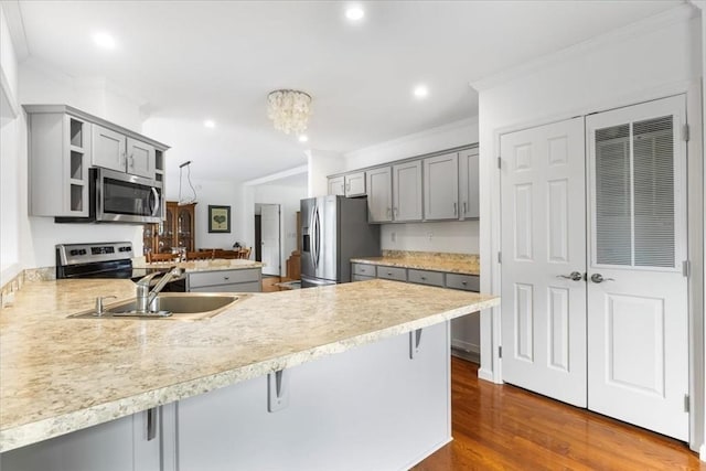23 Brookstone Unit 23, Bridgewater, MA 02324 - kitchen featuring appliances with stainless steel finishes, gray cabinetry, crown molding, a peninsula, and a sink
