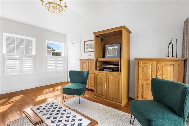 23 Brookstone Unit 23, Bridgewater, MA 02324 - living area with vaulted ceiling, a chandelier, light wood finished floors, and baseboards