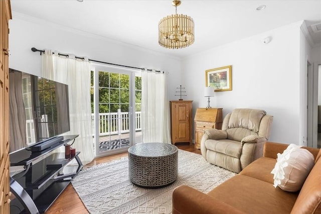 23 Brookstone Unit 23, Bridgewater, MA 02324 - living room featuring crown molding, wood finished floors, and a chandelier