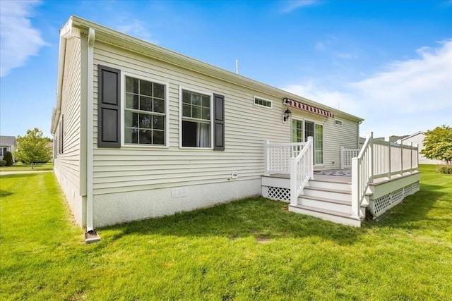 23 Brookstone Unit 23, Bridgewater, MA 02324 - rear view of house with crawl space, a wooden deck, and a yard