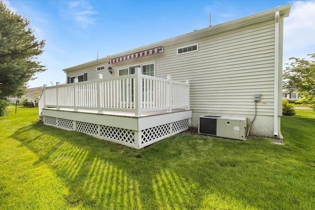 23 Brookstone Unit 23, Bridgewater, MA 02324 - back of house featuring central AC, a deck, and a lawn