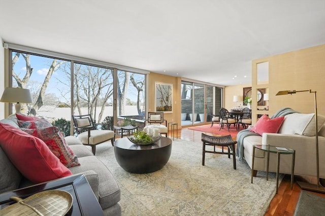 living room featuring recessed lighting, floor to ceiling windows, and wood finished floors