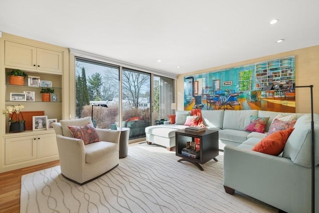 living area featuring light wood-type flooring, expansive windows, and recessed lighting