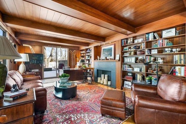 interior space with wood ceiling, built in features, beamed ceiling, and a fireplace with flush hearth