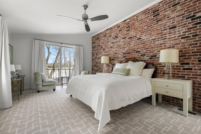 bedroom with a ceiling fan, access to outside, crown molding, and brick wall