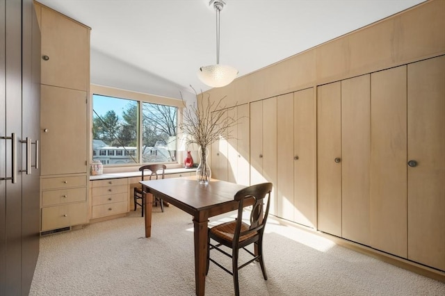 dining space featuring light colored carpet, vaulted ceiling, and visible vents