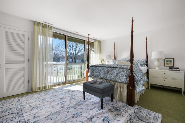 carpeted bedroom featuring access to outside and a wall of windows