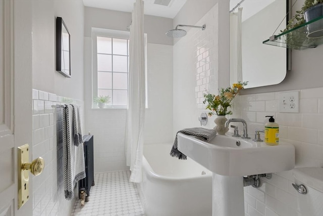 full bath featuring visible vents, wainscoting, tile patterned flooring, shower / bath combination with curtain, and tile walls