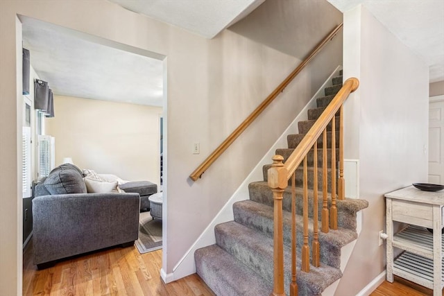 2 Strawstone Ln, Norton, MA 02766 - stairs with wood finished floors and baseboards