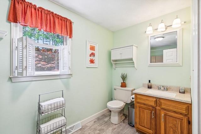 2 Strawstone Ln, Norton, MA 02766 - bathroom featuring wood finished floors, vanity, toilet, and baseboards