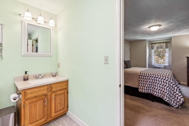 2 Strawstone Ln, Norton, MA 02766 - bathroom featuring vanity, ensuite bathroom, and baseboards