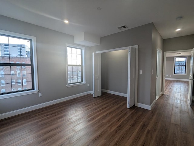 13 Nahant St Unit 3A, Lynn, MA 01902 - unfurnished bedroom featuring dark wood-style flooring, multiple windows, baseboards, and recessed lighting