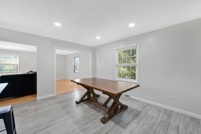 dining area featuring light wood-style floors, baseboards, and a healthy amount of sunlight
