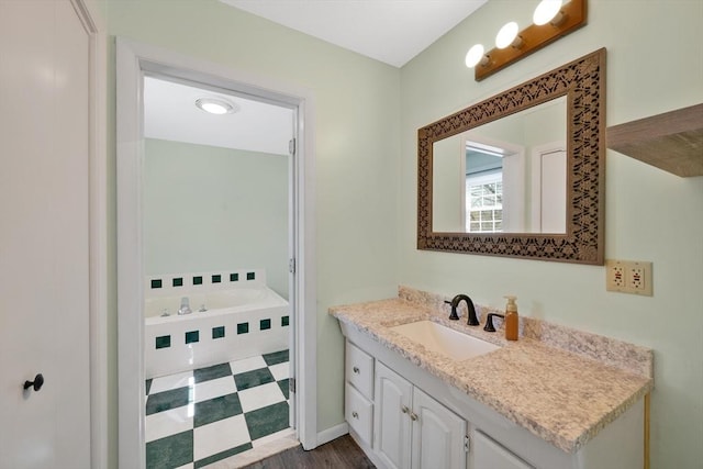 bathroom with vanity and a garden tub
