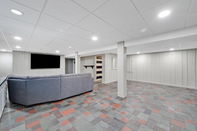living room with recessed lighting and a paneled ceiling