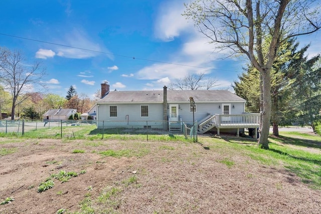 rear view of property with fence, a wooden deck, and a chimney