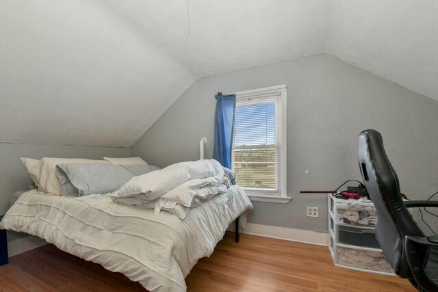 127 Beacon St, Chelsea, MA 02150 - bedroom with wood finished floors, vaulted ceiling, and baseboards