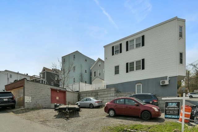 127 Beacon St, Chelsea, MA 02150 - view of front of house with a wall mounted air conditioner and uncovered parking