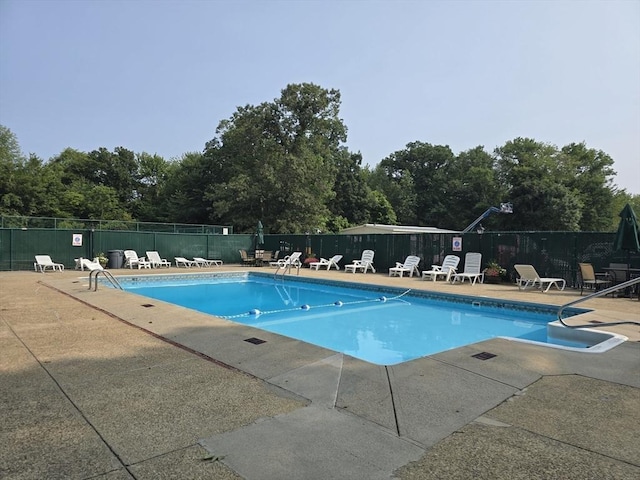 55 Greentree Ln Unit 27, Weymouth, MA 02190 - community pool featuring a patio and view of wooded area