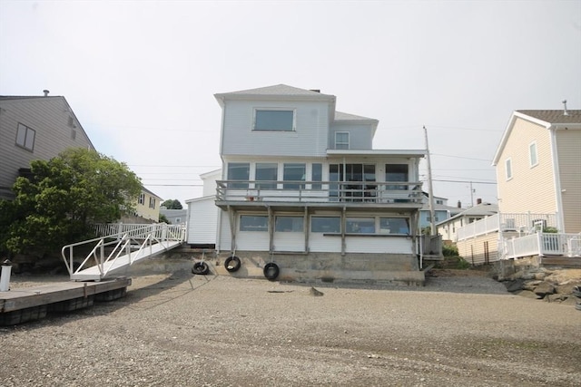 back of property featuring a balcony