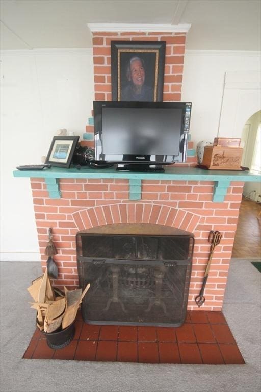 interior details with a fireplace and carpet flooring