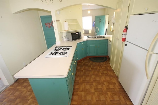 kitchen featuring dark parquet floors, white appliances, sink, and kitchen peninsula