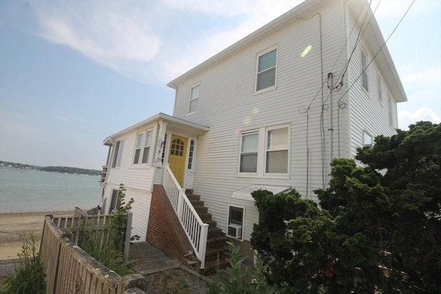 back of property featuring a water view