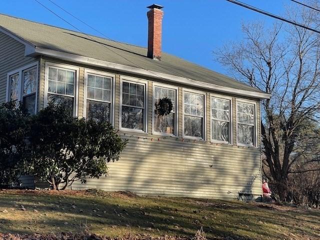 rear view of house with a lawn