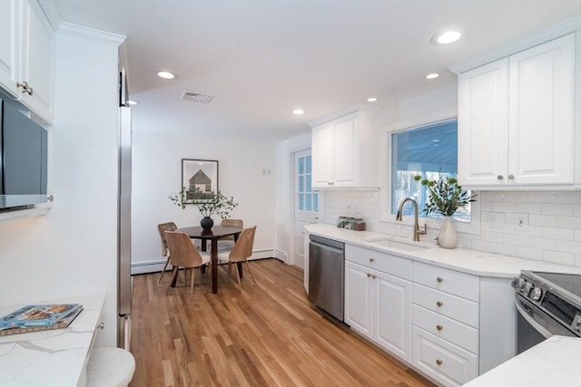 kitchen with white cabinets, stainless steel appliances, and sink