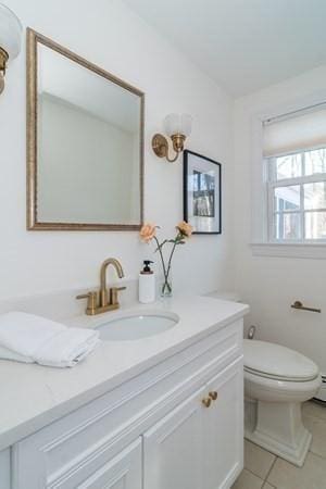 bathroom featuring tile patterned floors, vanity, and toilet