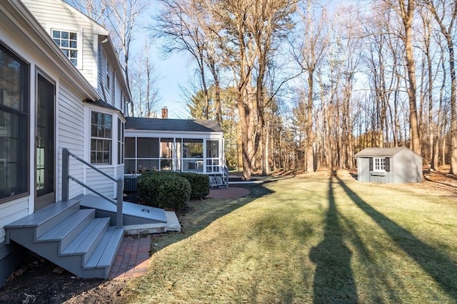 view of yard with a sunroom and a storage unit