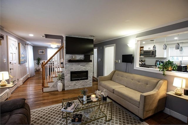 10 Albermarle St, Methuen, MA 01844 - living area featuring wood finished floors, crown molding, a fireplace, stairs, and recessed lighting