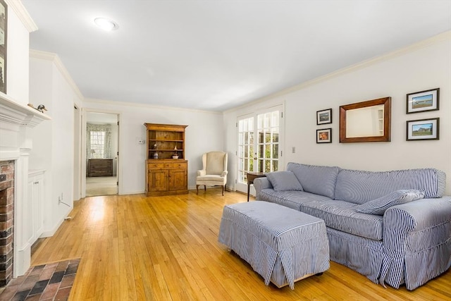 53 Wingfoot Dr, Barnstable, MA 02675 - living area with ornamental molding, plenty of natural light, light wood-style floors, and a fireplace