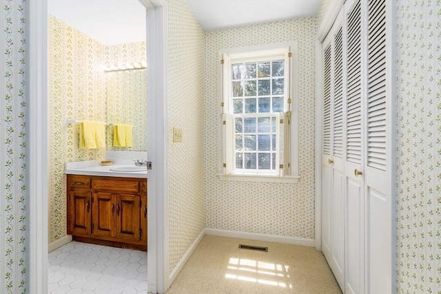 53 Wingfoot Dr, Barnstable, MA 02675 - bathroom featuring wallpapered walls, vanity, baseboards, and a closet