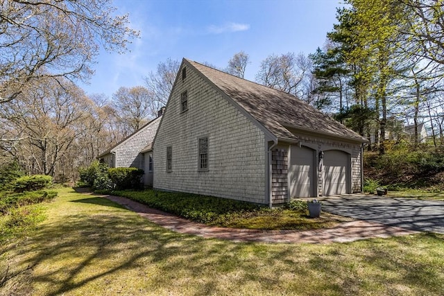53 Wingfoot Dr, Barnstable, MA 02675 - view of home's exterior featuring a detached garage, a yard, and roof with shingles