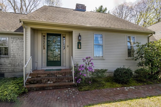 53 Wingfoot Dr, Barnstable, MA 02675 - view of exterior entry featuring a chimney and a shingled roof