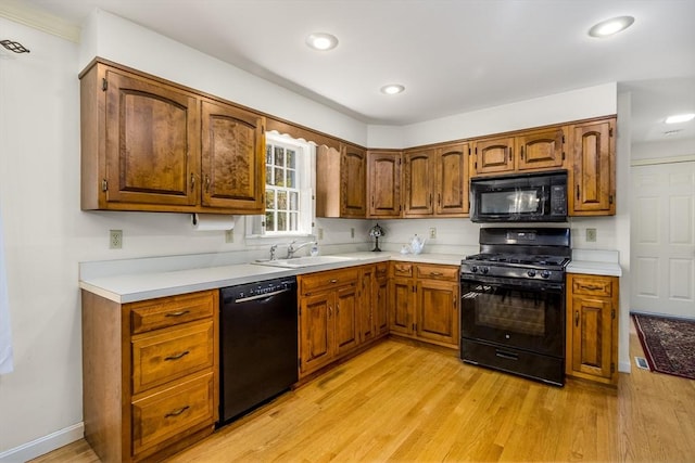 53 Wingfoot Dr, Barnstable, MA 02675 - kitchen with black appliances, a sink, light wood-style flooring, recessed lighting, and brown cabinets