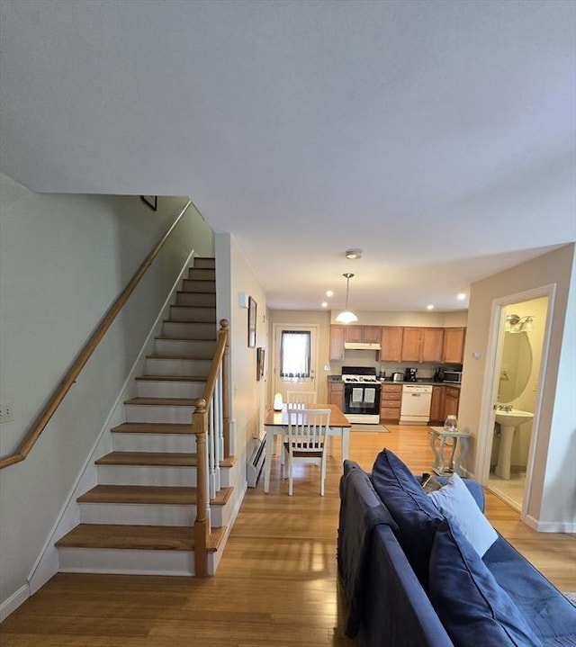 94 Barton St Unit 3, Pawtucket, RI 02860 - living room featuring light wood finished floors, stairs, recessed lighting, baseboards, and a baseboard heating unit