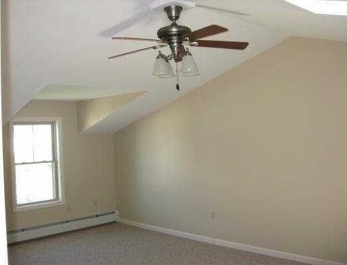 94 Barton St Unit 3, Pawtucket, RI 02860 - bonus room with a baseboard radiator, vaulted ceiling, baseboards, and a ceiling fan