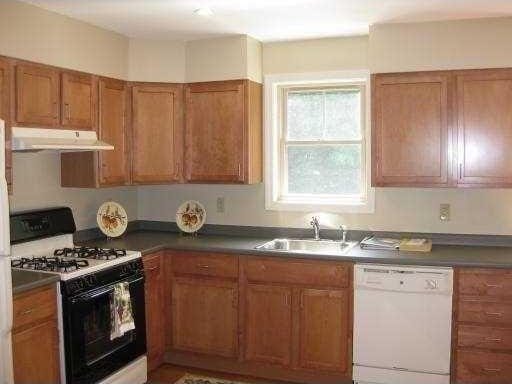 94 Barton St Unit 3, Pawtucket, RI 02860 - kitchen featuring dishwasher, range with gas stovetop, under cabinet range hood, a sink, and brown cabinetry