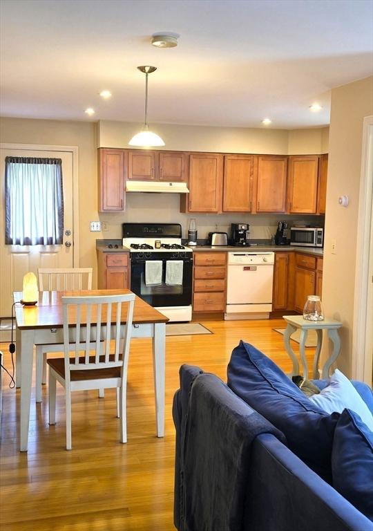 94 Barton St Unit 3, Pawtucket, RI 02860 - kitchen featuring gas stove, dishwasher, stainless steel microwave, under cabinet range hood, and open floor plan