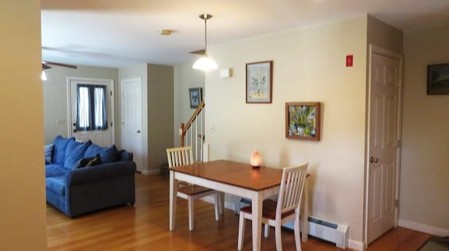 94 Barton St Unit 3, Pawtucket, RI 02860 - dining room featuring baseboard heating, light wood-style flooring, stairway, and baseboards