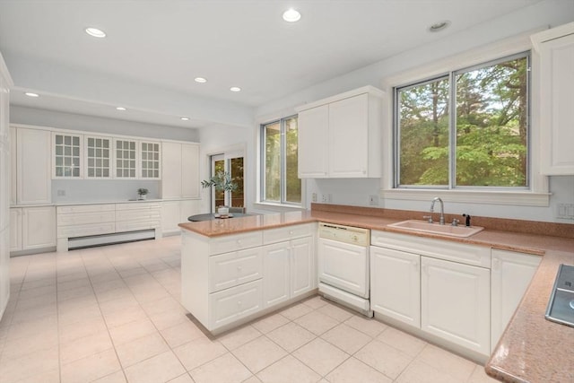 204 Allandale Rd Unit A, Boston, MA 02467 - kitchen featuring dishwasher, a sink, a baseboard radiator, white cabinets, and a peninsula