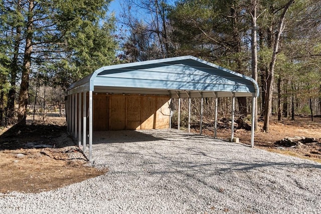 view of outdoor structure with a carport and driveway