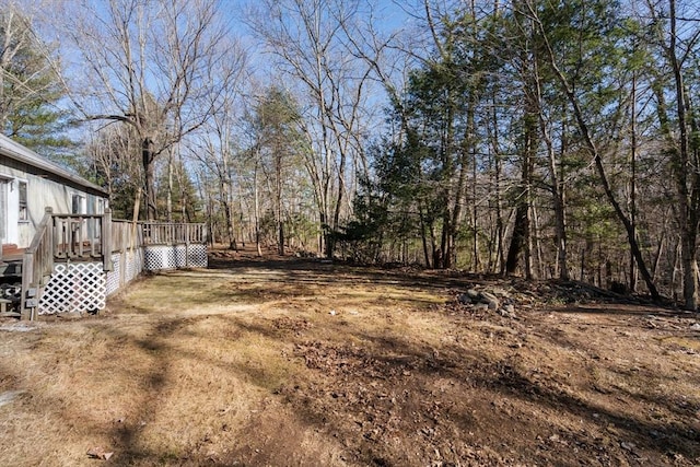 view of yard featuring a wooden deck