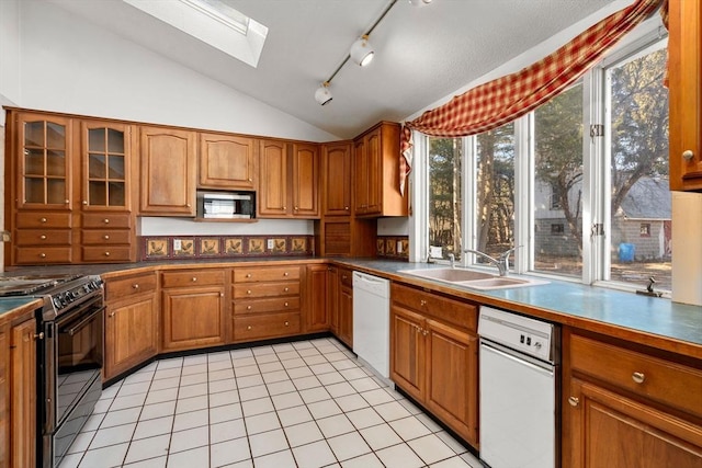 kitchen featuring a sink, stove, dishwasher, stainless steel microwave, and brown cabinets