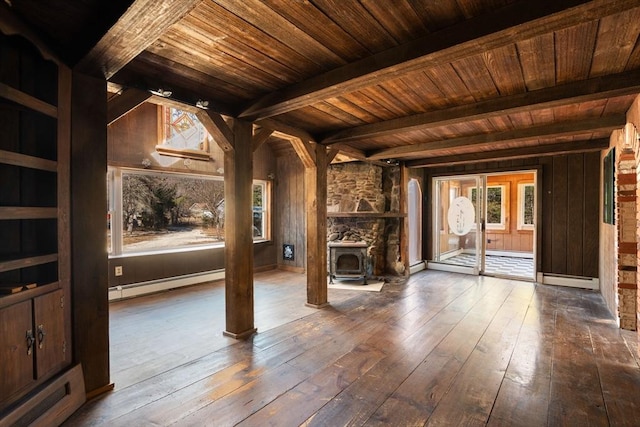 interior space featuring wood ceiling, a baseboard heating unit, wood-type flooring, and beam ceiling