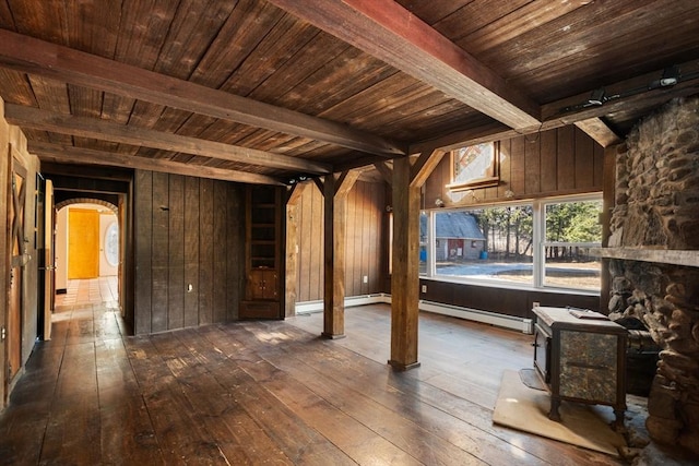 interior space featuring arched walkways, beamed ceiling, wood ceiling, and dark wood-type flooring